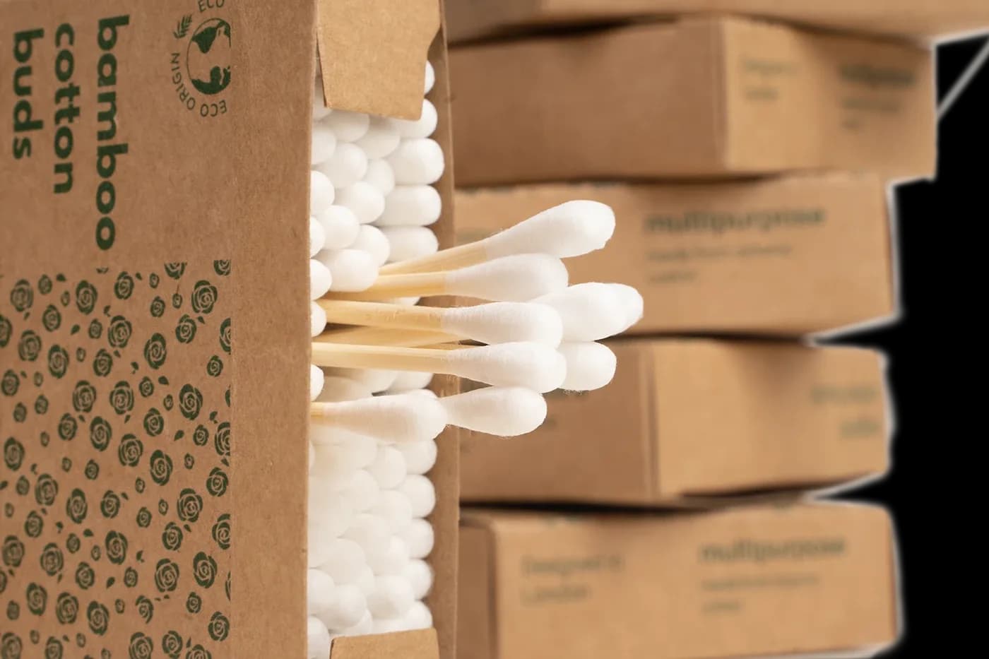 Open box of bamboo cotton buds beside stacked small boxes