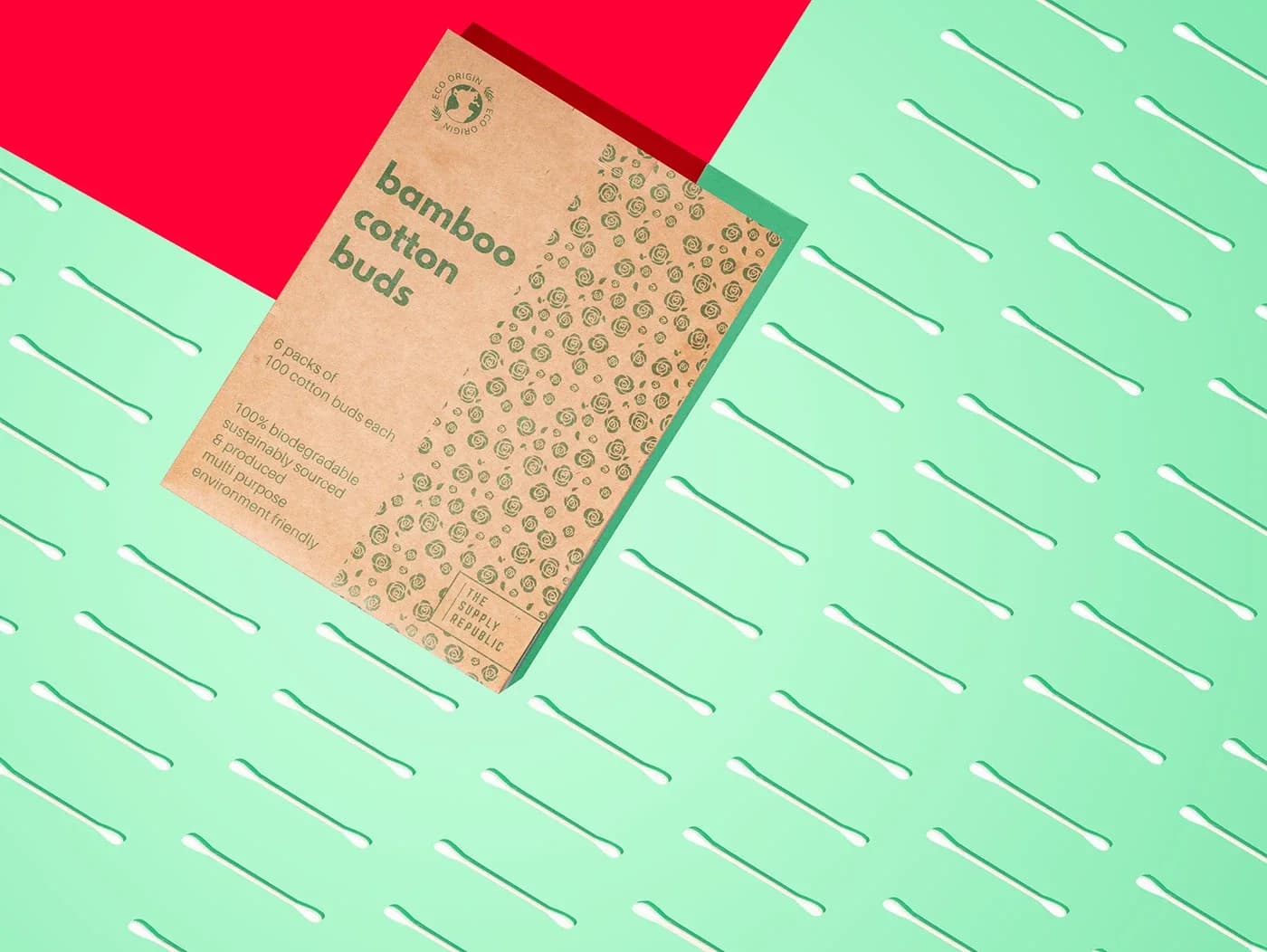 Cotton buds box on a mint background with a red corner