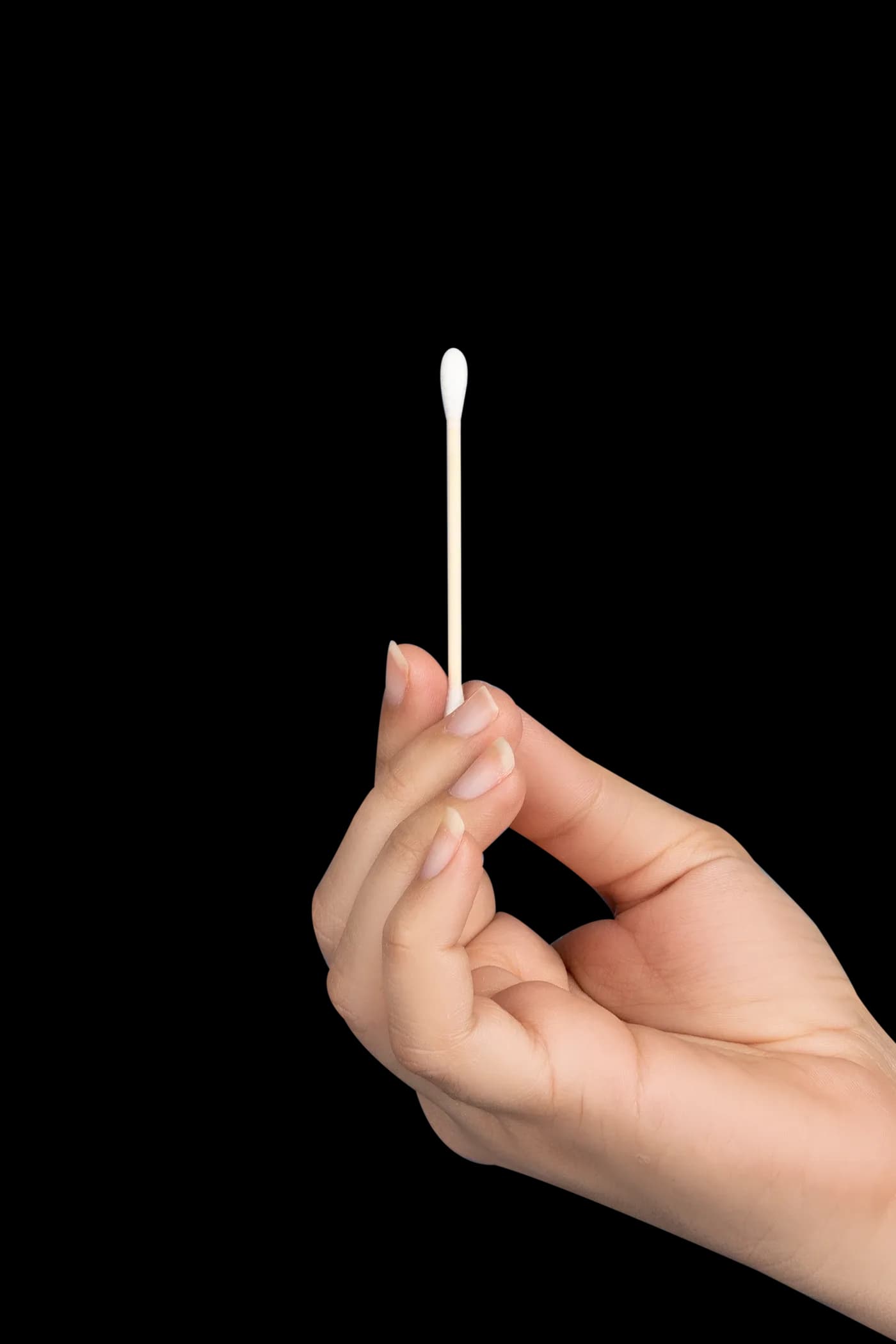 Hand holding a single bamboo cotton bud