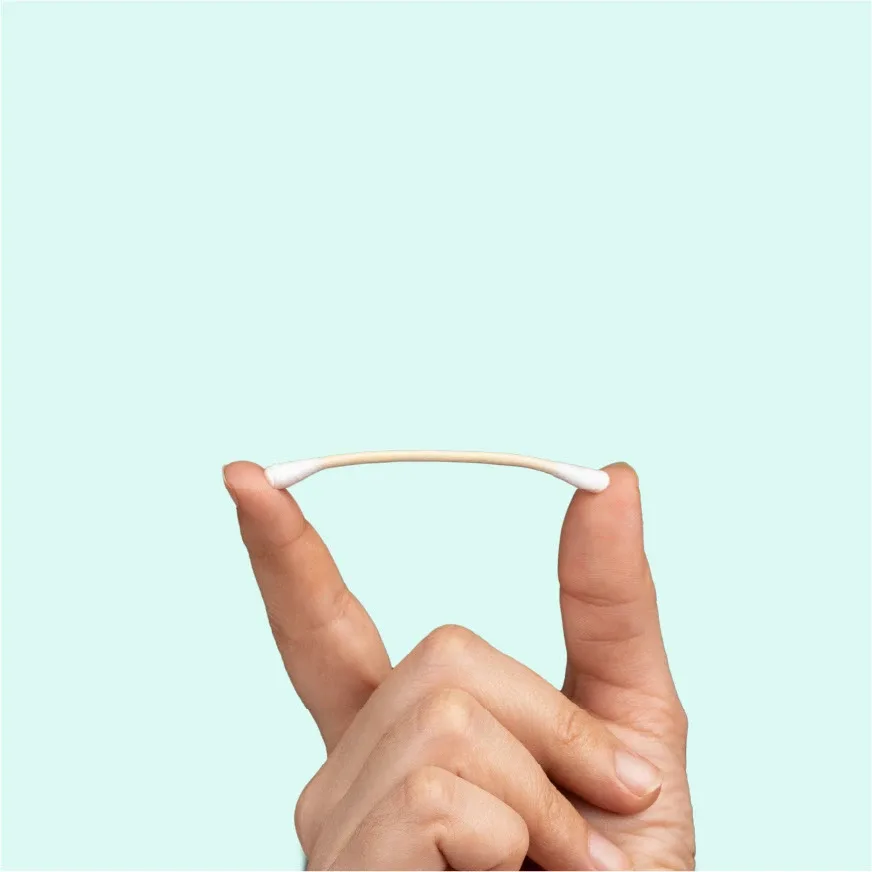 Fingers bending a cotton bud on a mint background