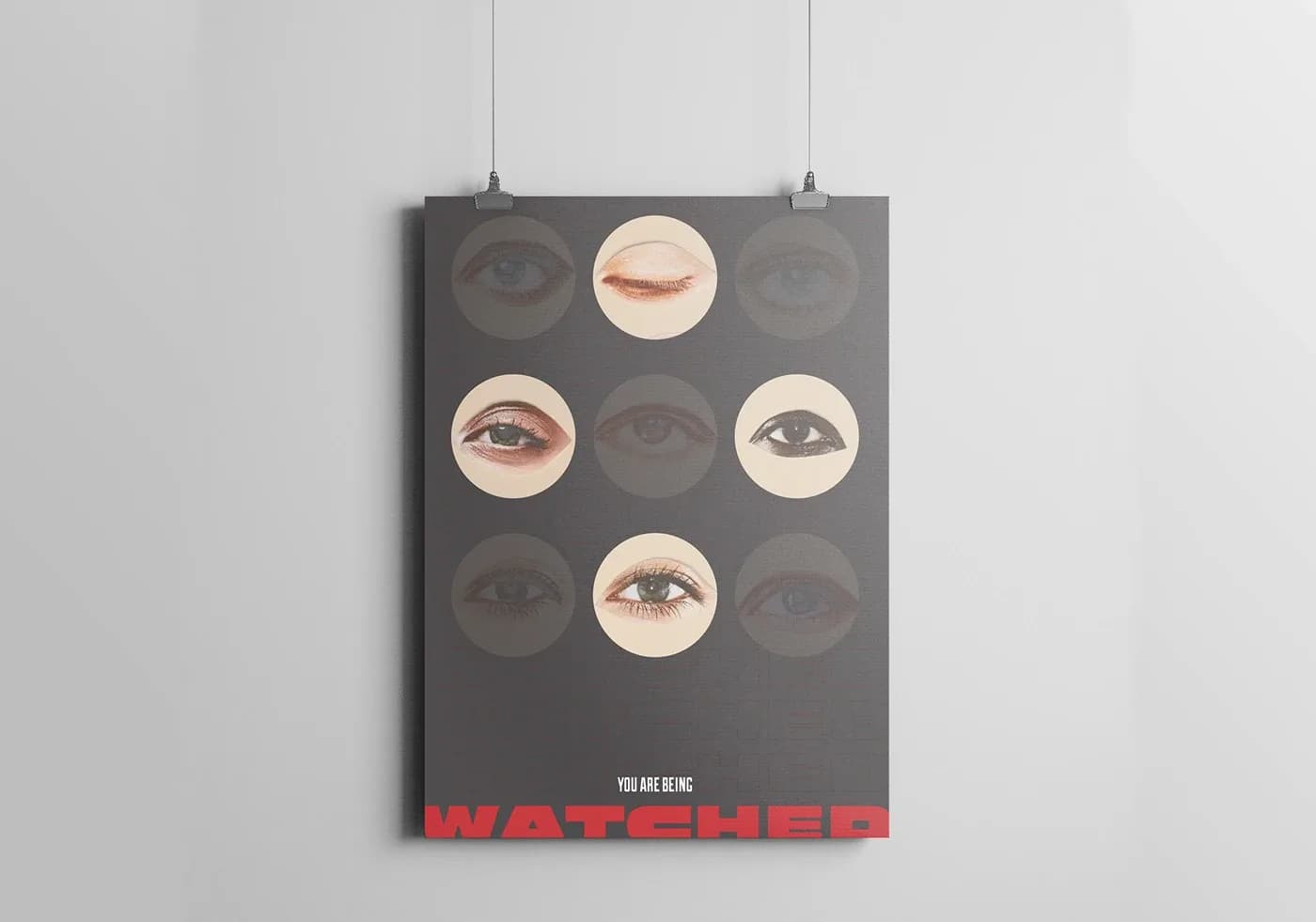 Hanging poster with a grid of eyes above a red WATCHED headline