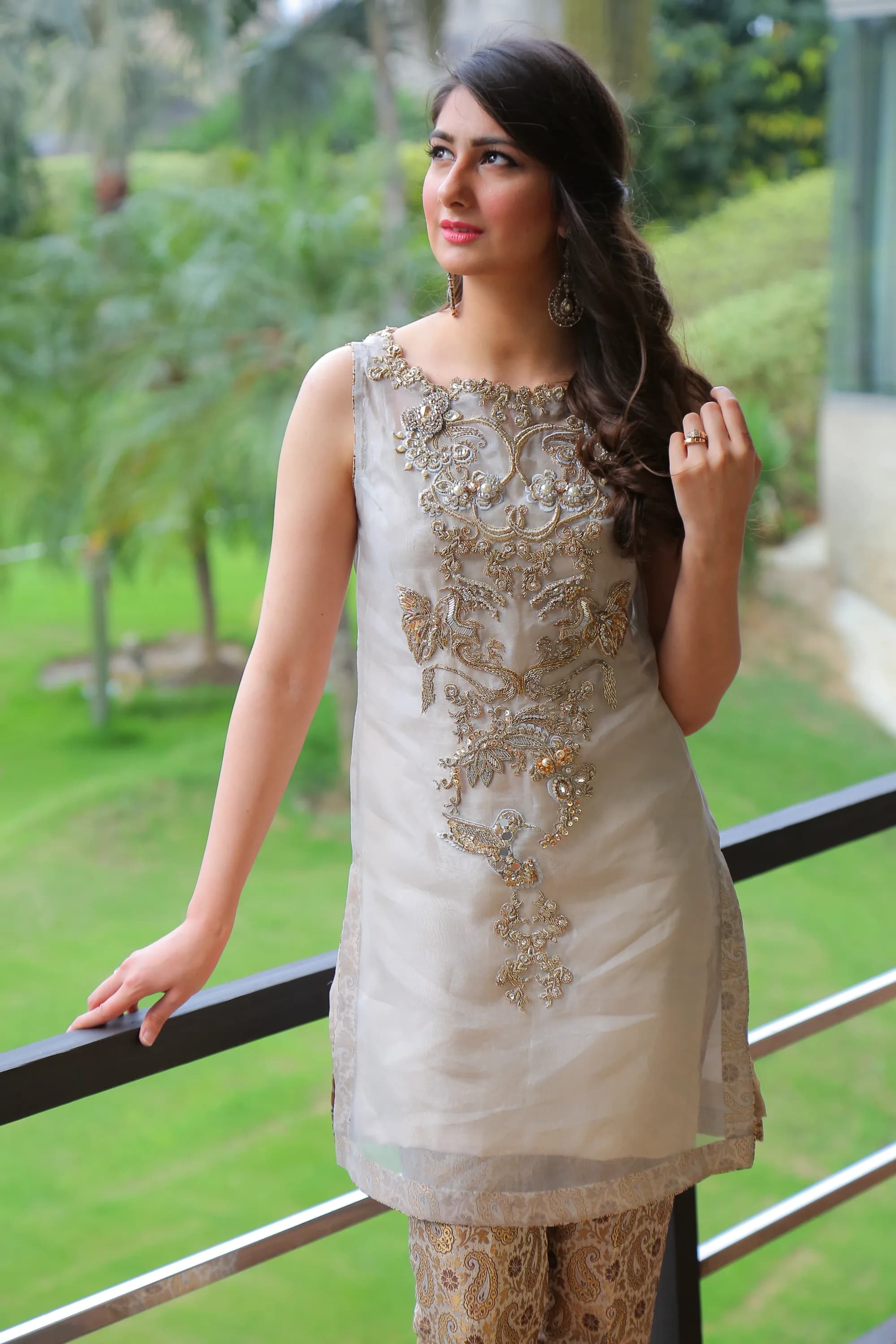 Close three-quarter view of gold embroidery on a sheer beige kurta