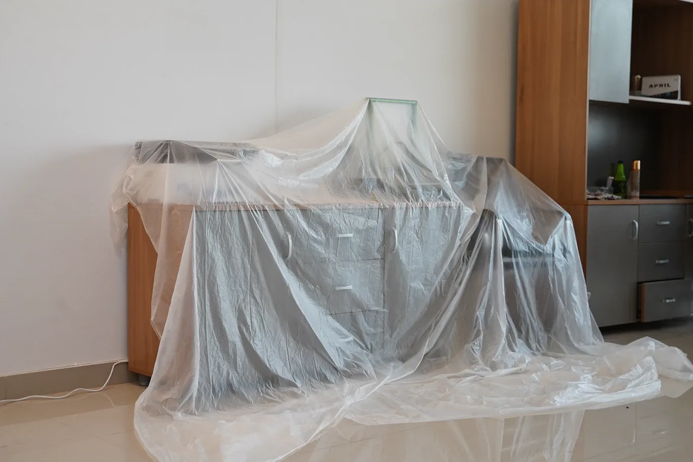 Furniture covered with a dust sheet in a room