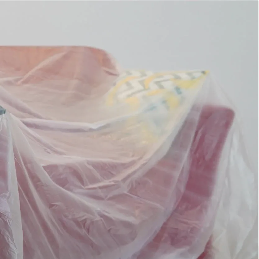 Close-up of a pink chair under a clear sheet