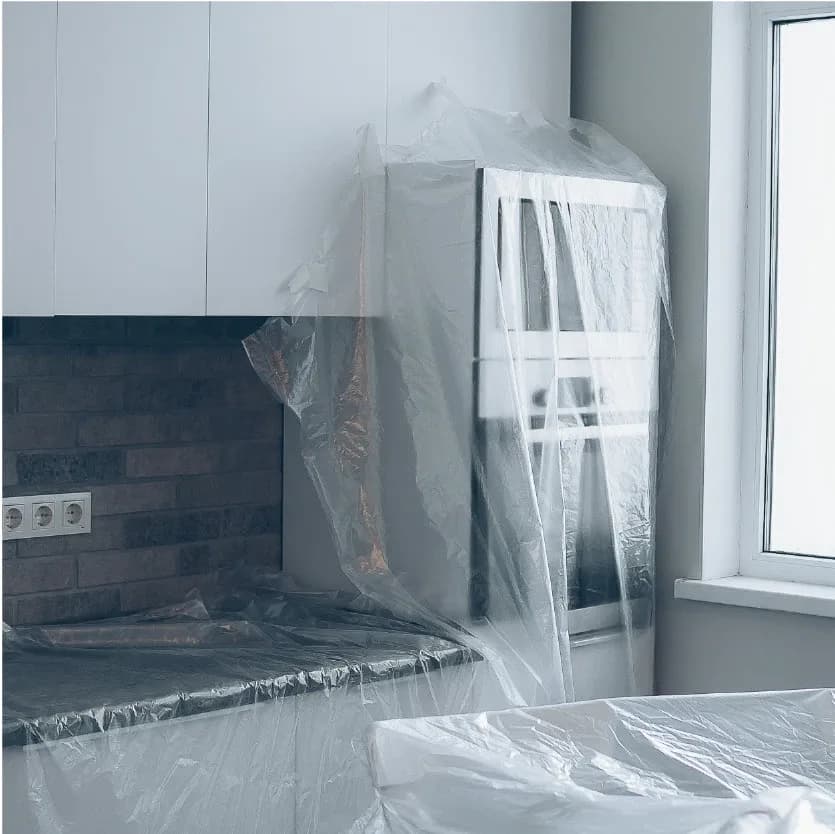 Kitchen appliances wrapped in plastic sheeting