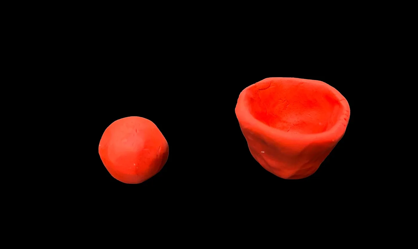 Red clay ball beside the finished clay bowl