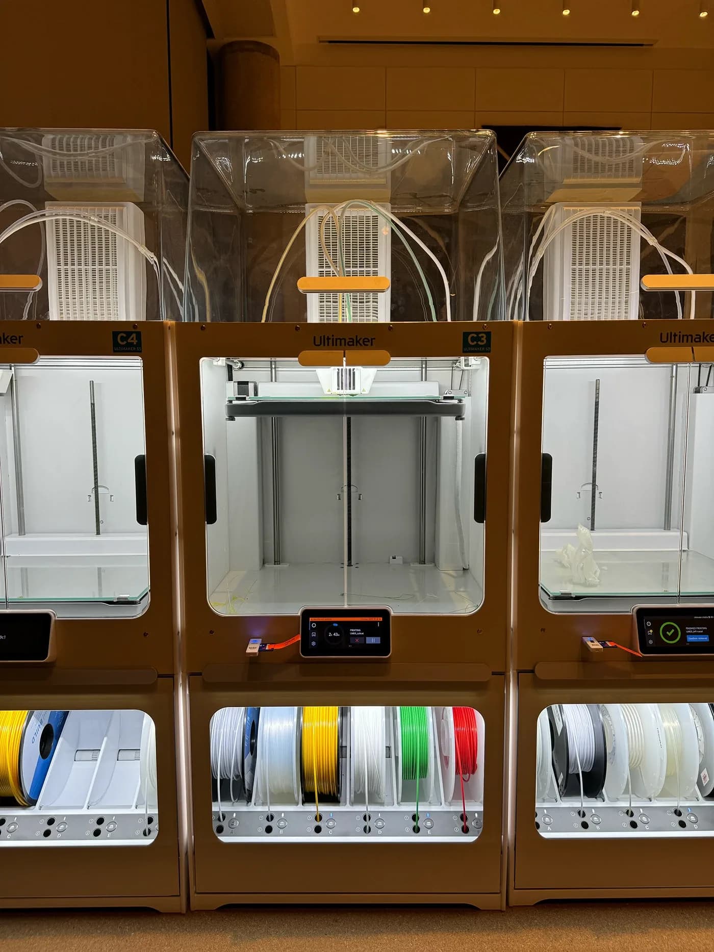 Row of Ultimaker 3D printers with filament spools