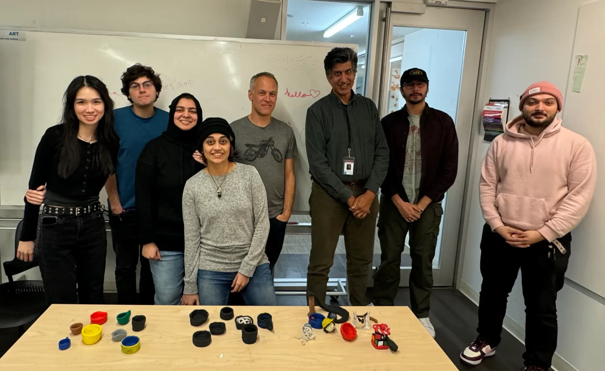 Workshop participants posing behind their clay pieces