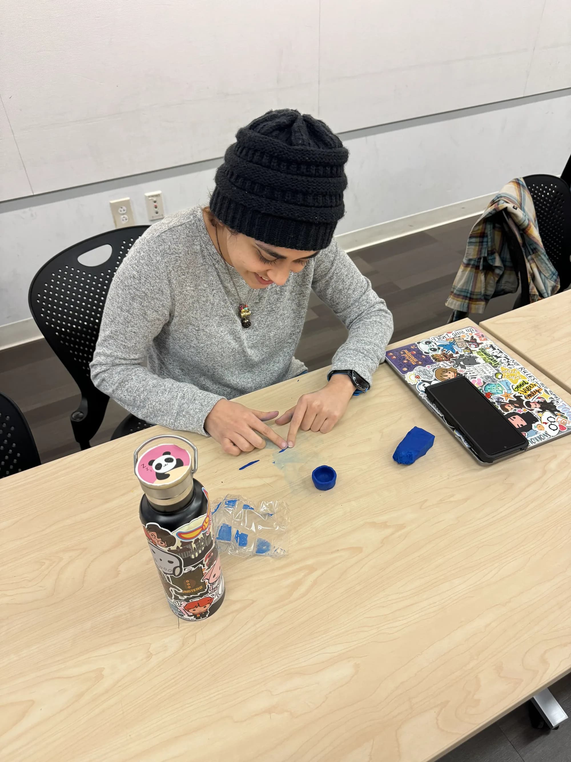 Workshop participant working with blue clay