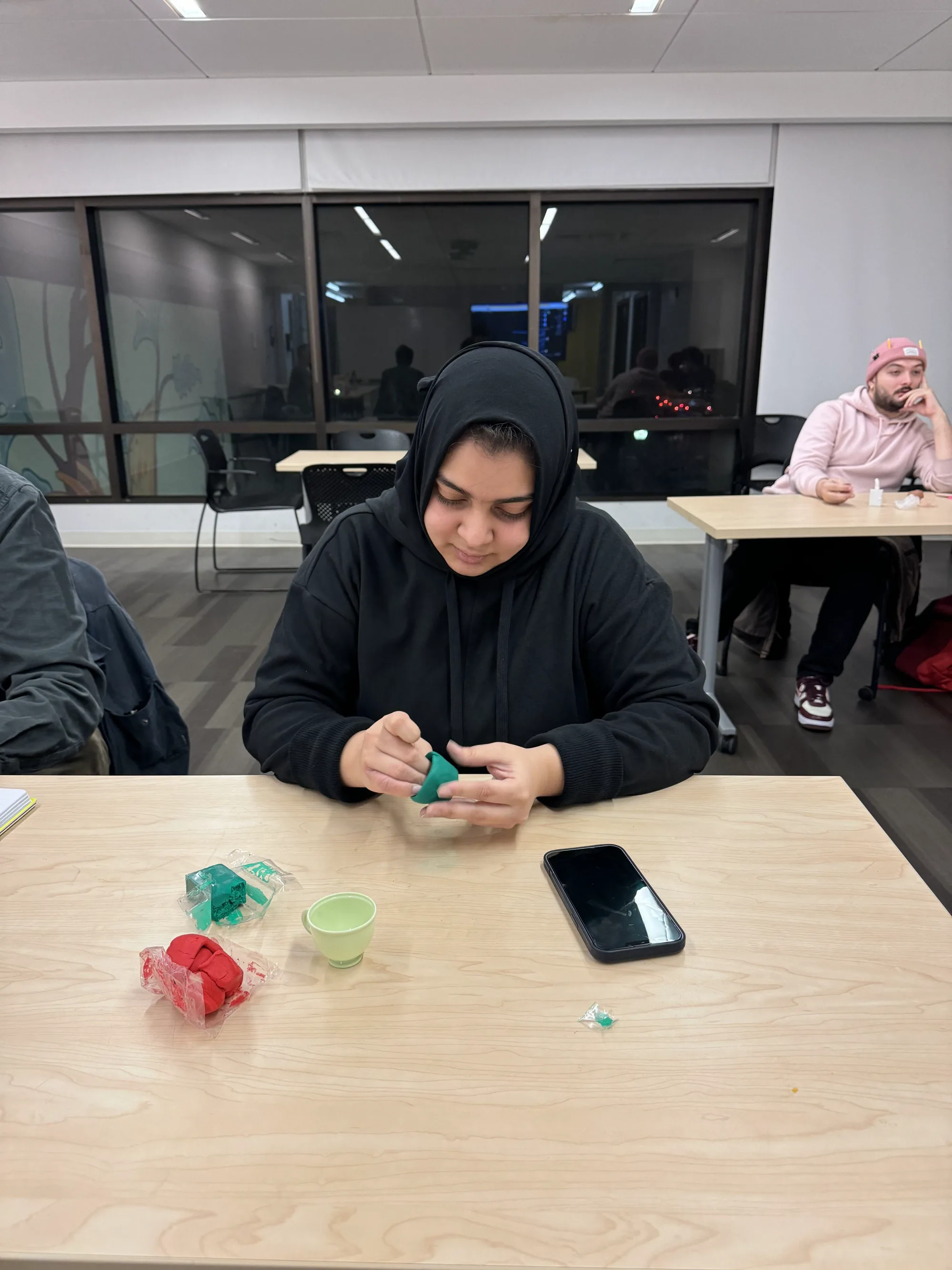 Workshop participant modeling green clay