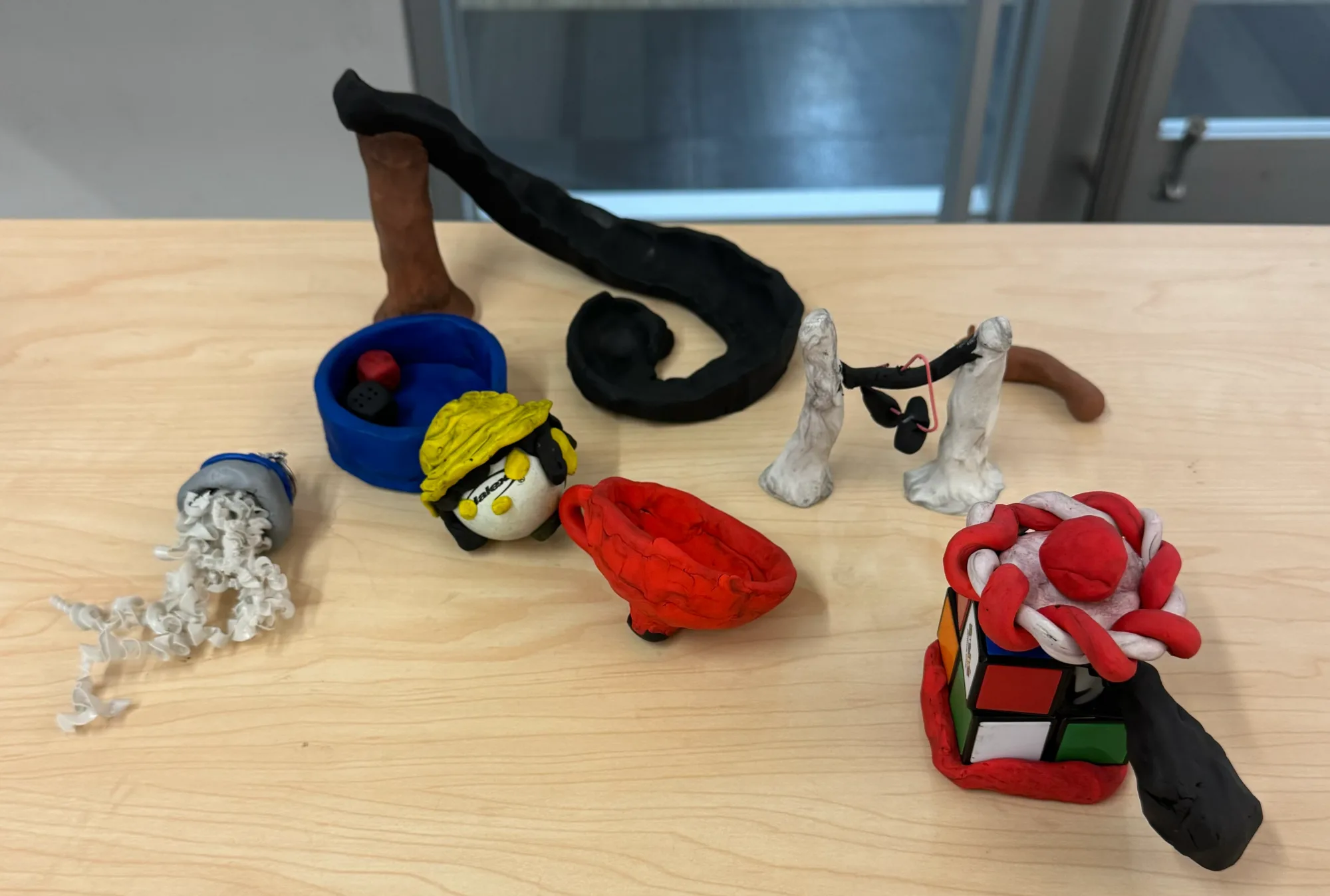 Assorted clay sculptures made by workshop participants
