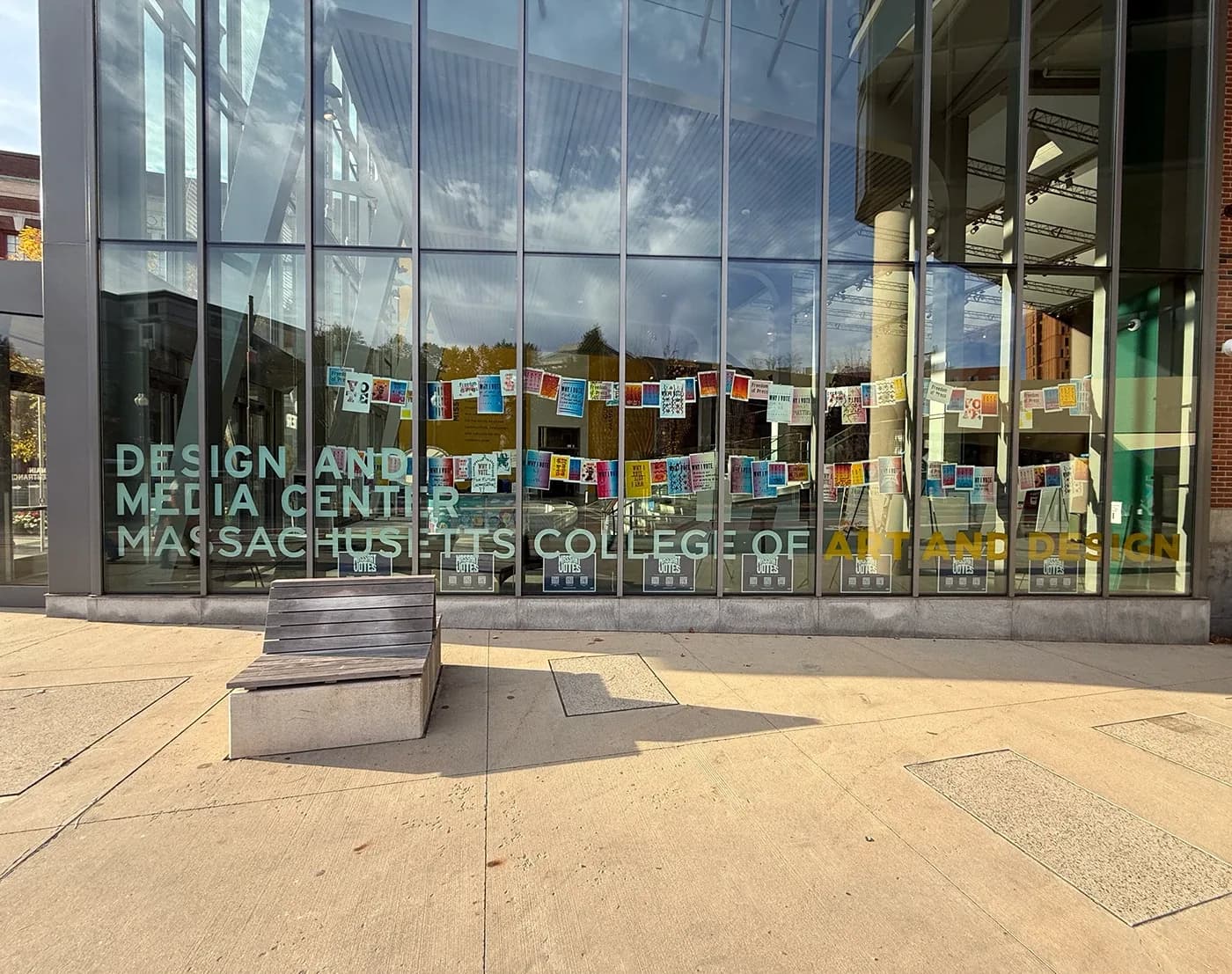Posters hung in the windows of MassArt's Design and Media Center