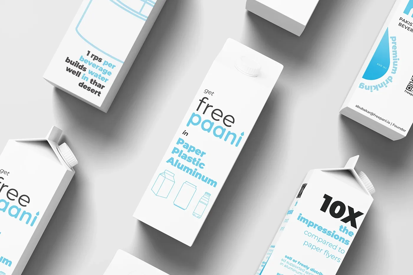 Overhead scatter of white FreePaani cartons showing different printed faces