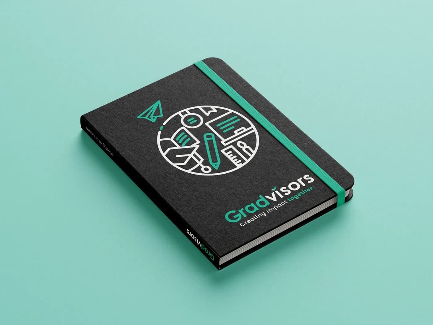 Black Gradvisors notebook with green elastic band and line illustration