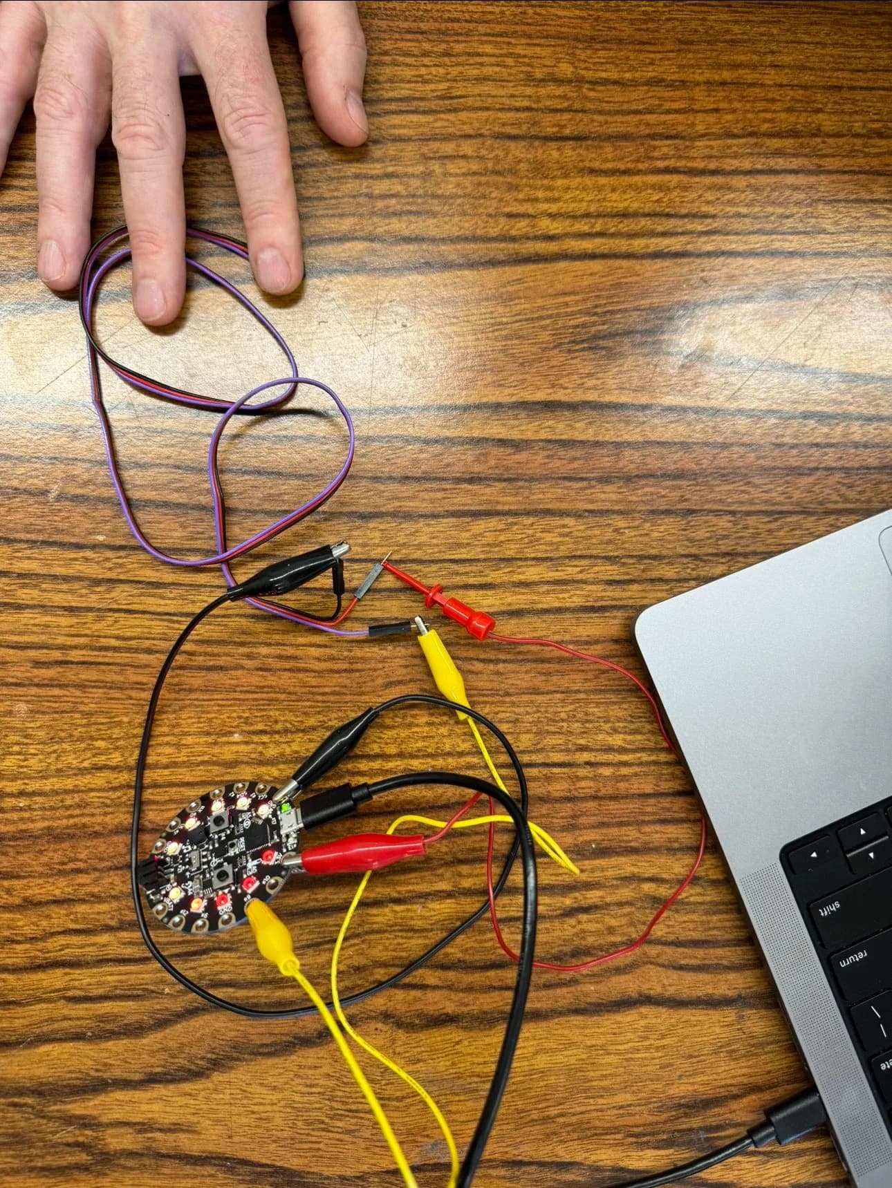Finger resting on a pulse sensor wired to a Circuit Playground