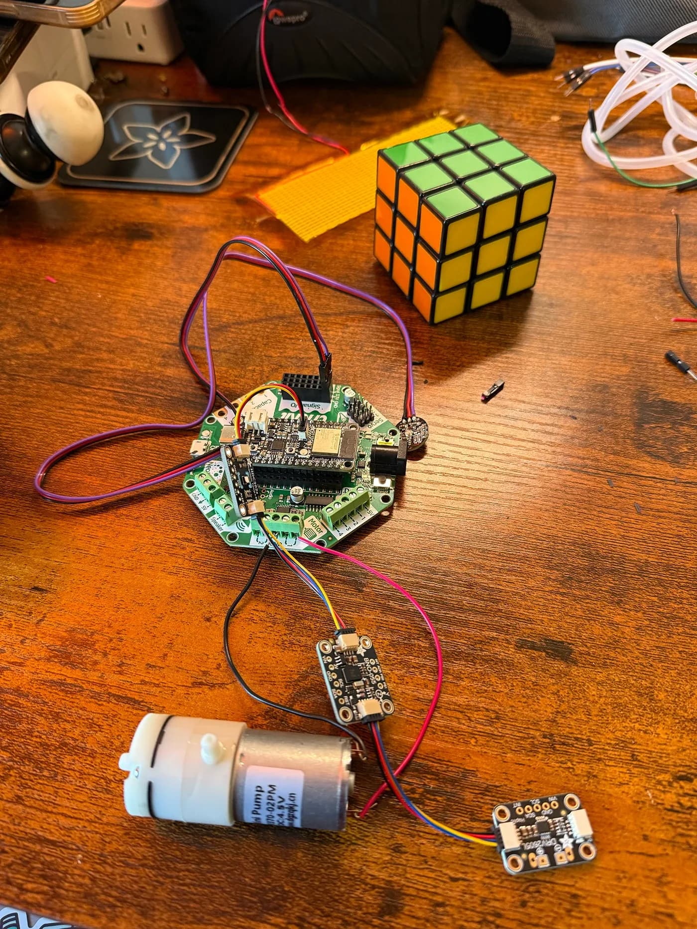 Microcontroller board wired to an air pump and sensor modules