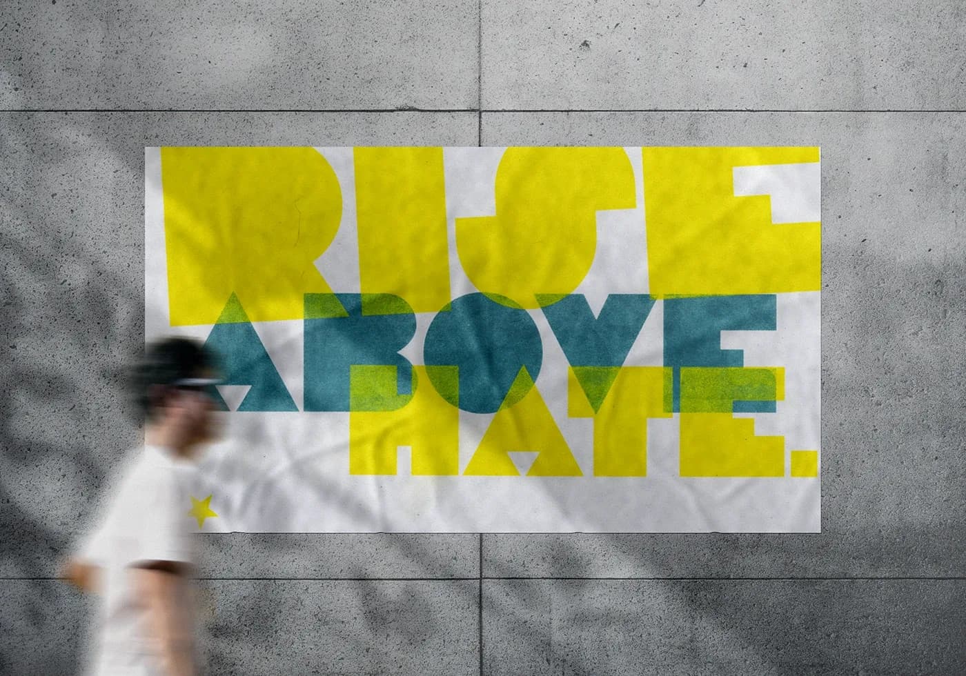 Yellow and teal Rise Above Hate poster on a concrete wall mockup