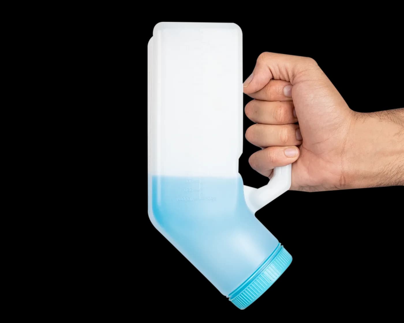 Hand holding the tilted bottle with blue liquid
