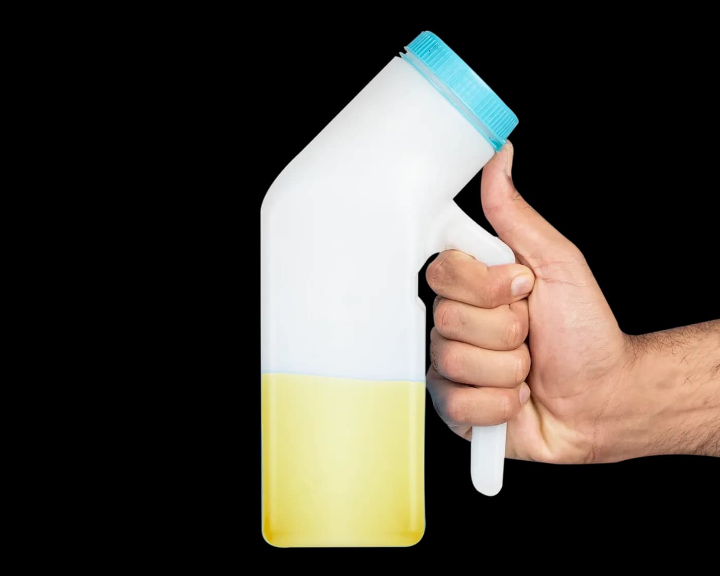 Hand gripping the bottle filled with yellow liquid