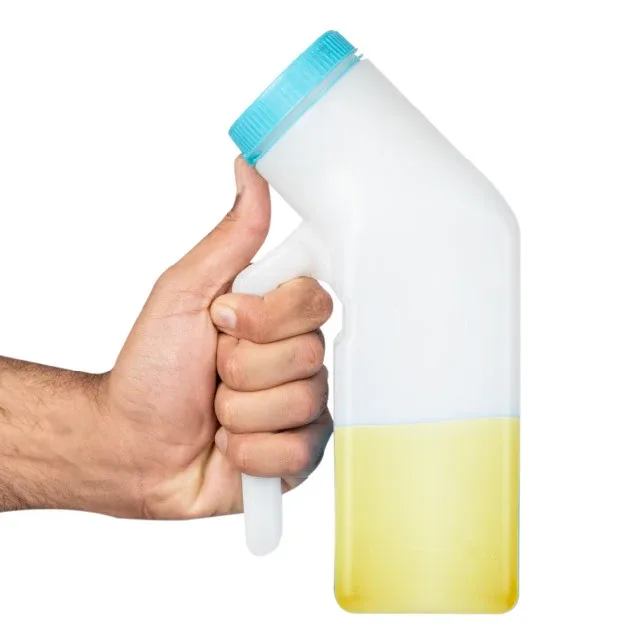 Hand gripping the bottle upright with yellow liquid