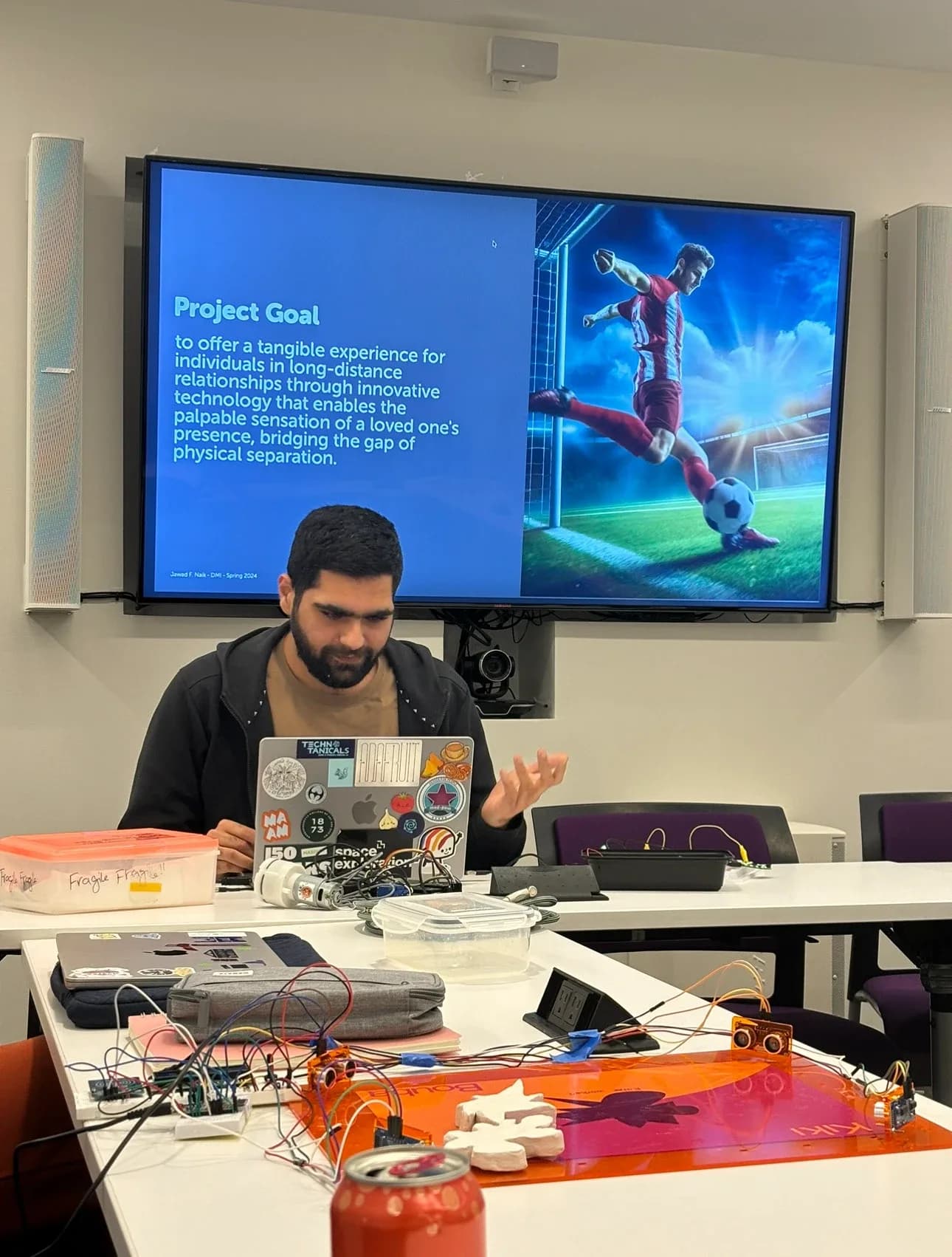 Presenting the project goal slide in a classroom at MIT