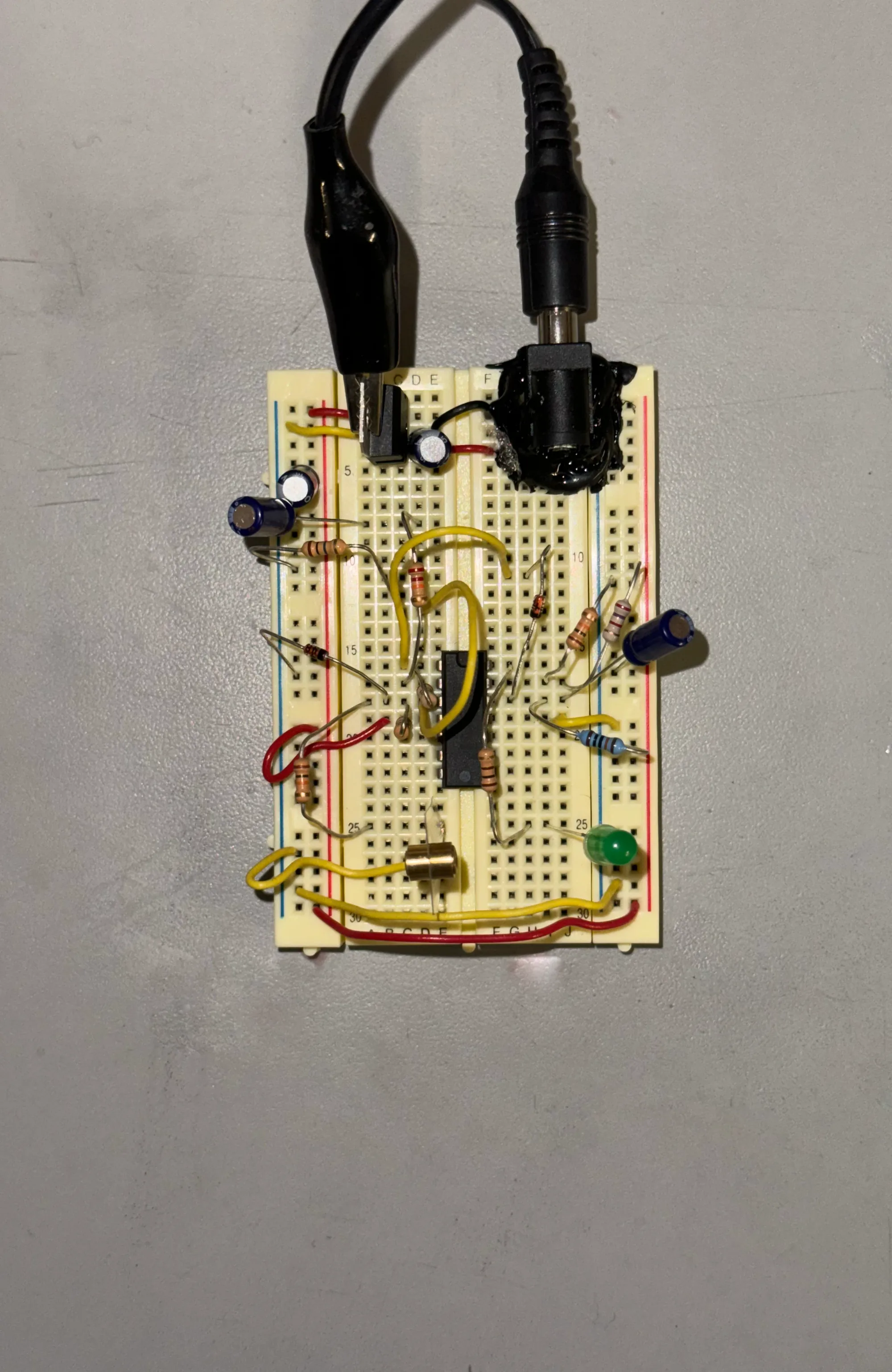 Top view of a breadboard with resistors, capacitors and a chip