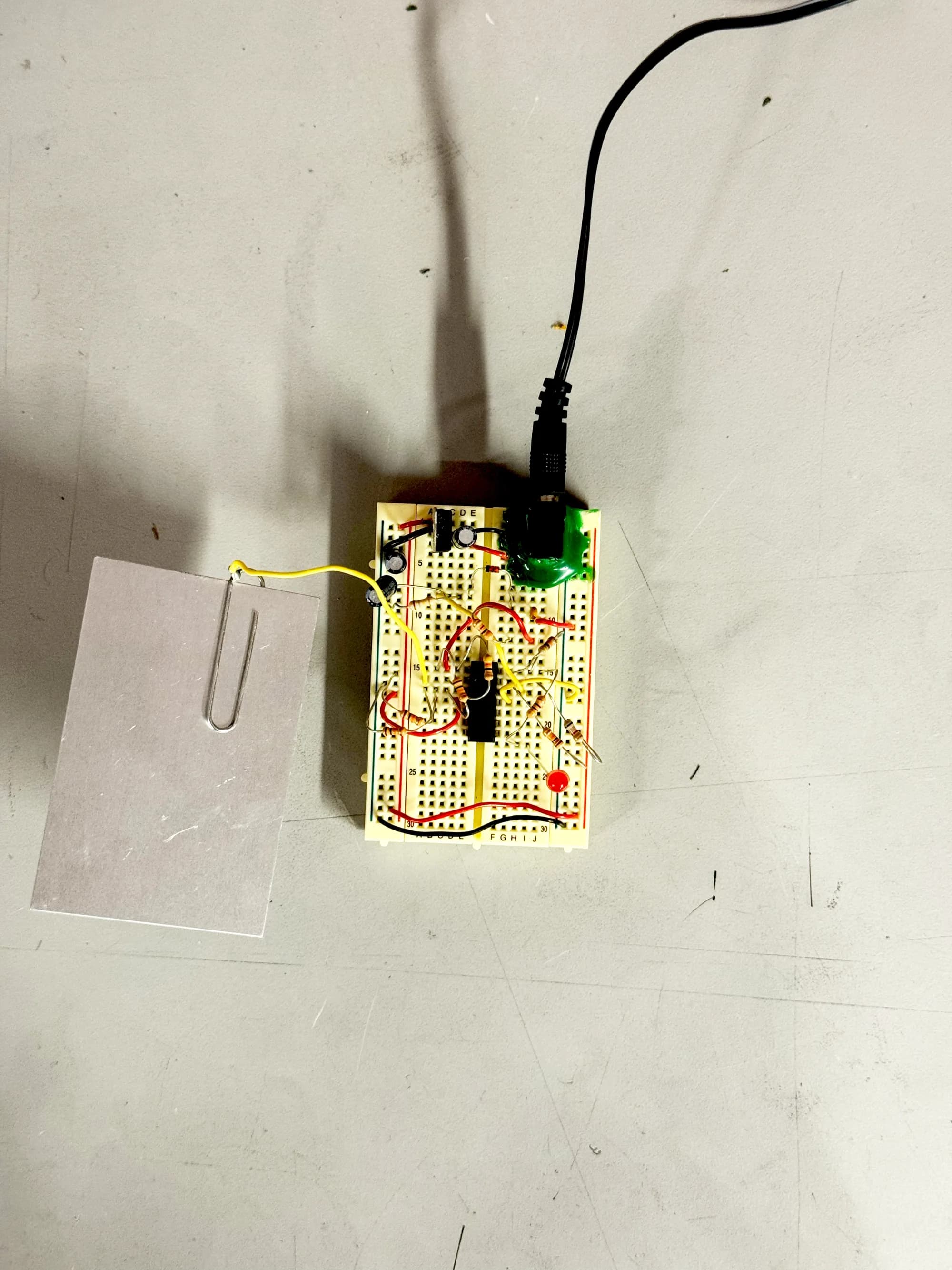 Capacitive touch circuit wired to a metal plate