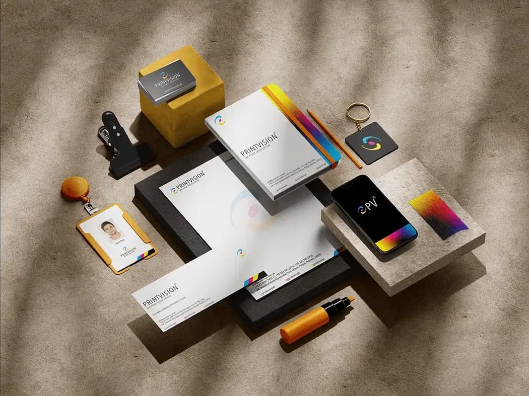 Stationery flatlay: business cards, letterhead, company profile, ID badge, keyring and phone