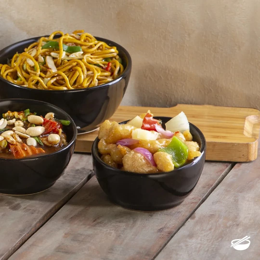 Bowls of noodles, peanut stir-fry and sweet and sour chicken