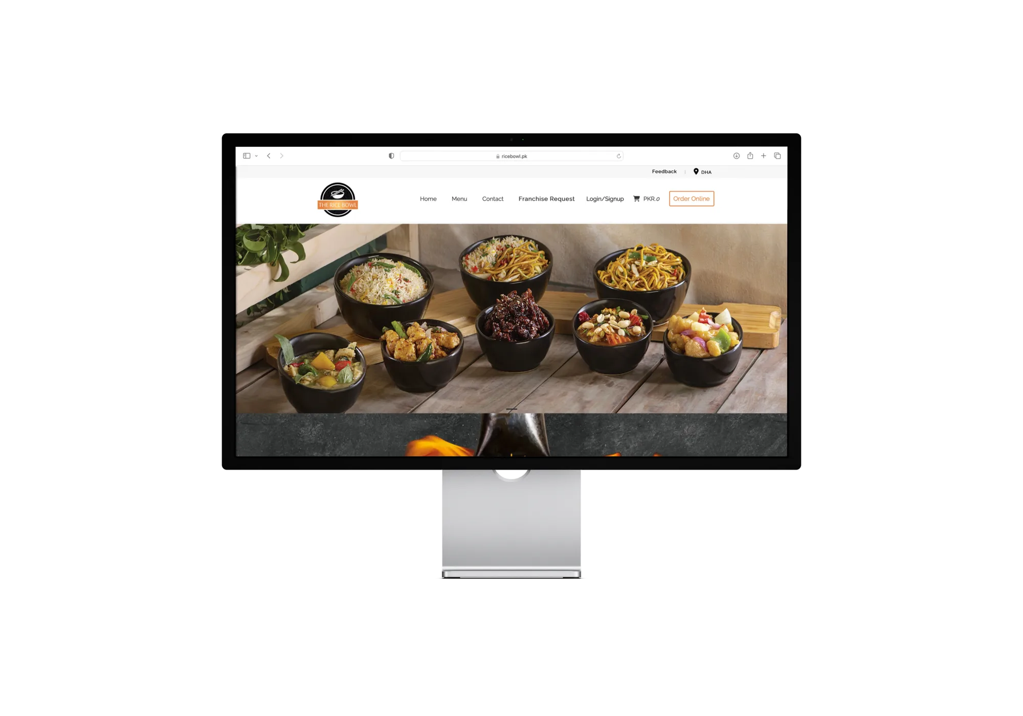 Desktop monitor showing The Rice Bowl homepage with rice bowls