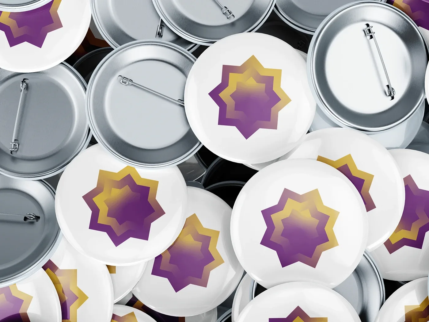 Pile of white pin buttons printed with the purple and gold star mark