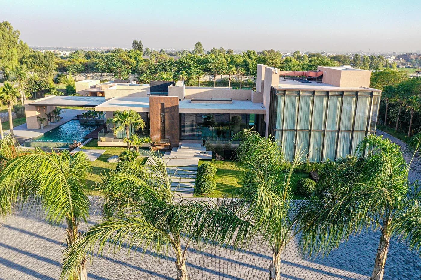 Aerial view of the modern house with pool and palm trees