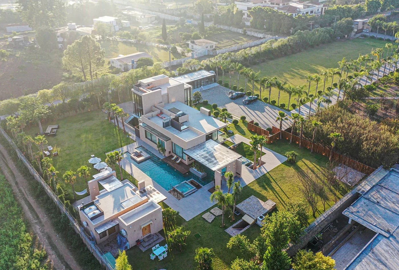 Top-down aerial of the house, pool and landscaped grounds