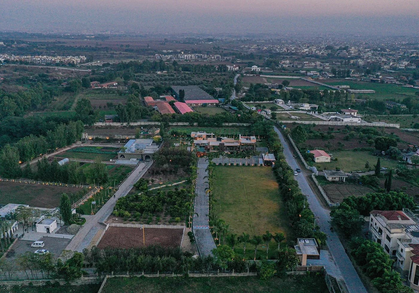 Aerial of the estate among surrounding fields at dusk