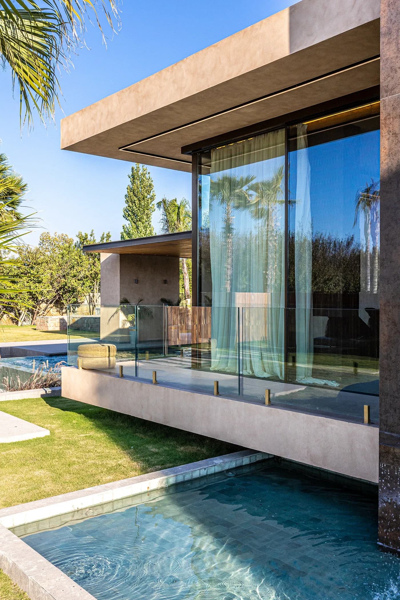 Glass-walled volume cantilevered over a water channel