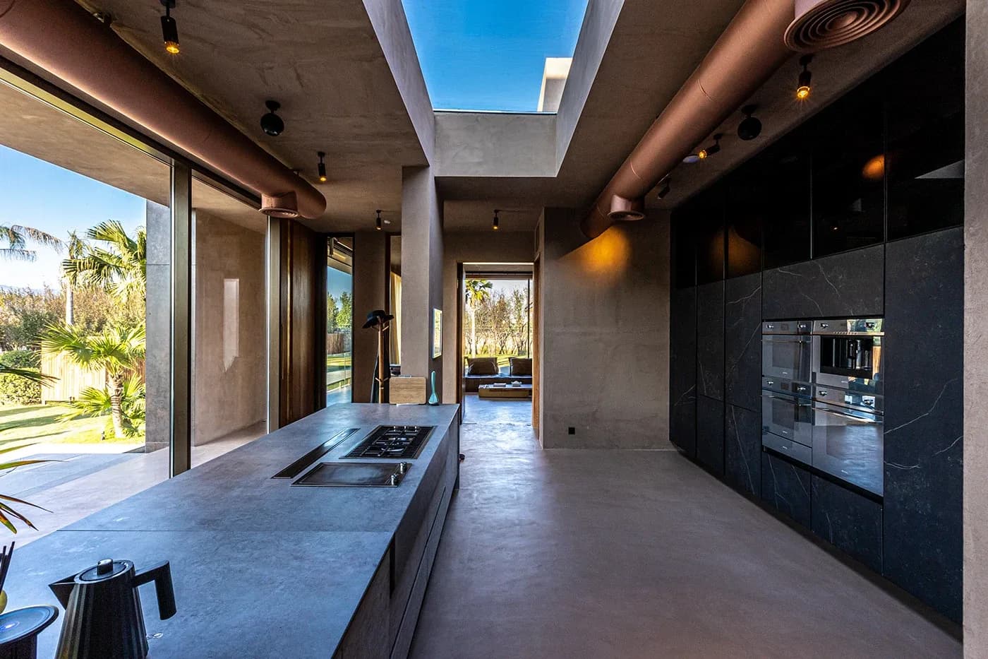 Kitchen island leading toward glass doors and garden