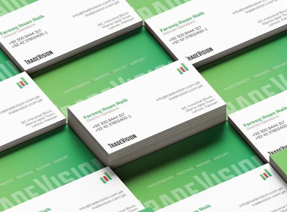 Rows of TradeVision business cards, white fronts and green backs