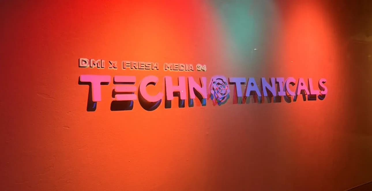 DMI x FreshMedia 24 Technotanicals sign on a red wall