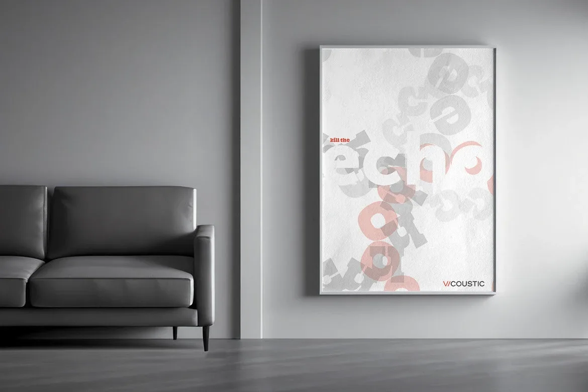 Framed Kill the Echo poster with scattered gray and coral letters beside a sofa